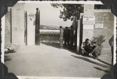 Men outside gate to cemetery at Castelfiortenino (ddr-densho-466-690)