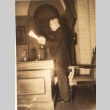A man standing at desk, reading document (ddr-njpa-4-75)