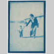 Woman and toddler walking near barracks (ddr-densho-329-1281)