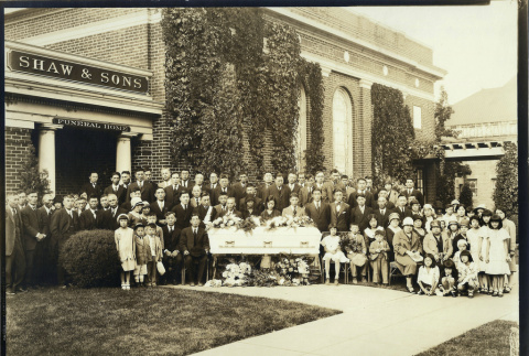 Funeral attendees in front of Shaw & Sons funeral home (ddr-densho-293-19)