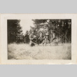Four men sitting in tall grass, drinking (ddr-densho-466-267)