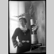 Tomoye (Nozawa) Takahashi posing by large vase (ddr-densho-426-2016)