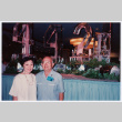 Bill and Tomi Iino in front of ice carving at banquet (ddr-densho-368-321)