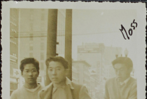 Three young men walking down the street (ddr-densho-321-1170)