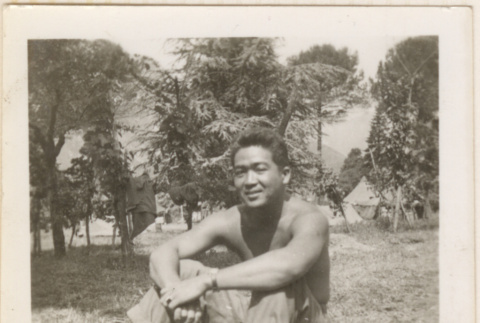 Shirtless man sitting in field (ddr-densho-466-316)