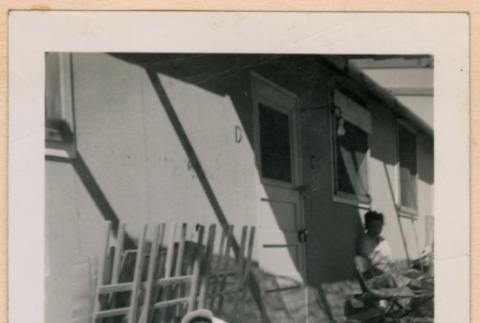 Baby sitting outside barracks (ddr-densho-329-1294)