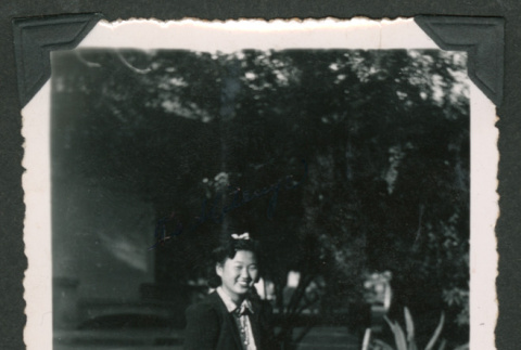 Girl kneeling in grass (ddr-densho-550-233)