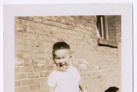 Photo of a toddler holding a lunch pail (ddr-densho-483-745)