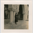 Tomoye (Nozawa) Takahashi standing under elaborately carved stone archway (ddr-densho-426-1878)