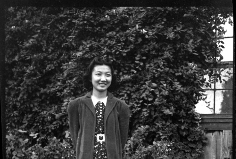 Mae Miwa in front of ivy-covered wall (ddr-densho-475-95)