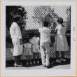 Yoshiko, William, Susan and Leslie Shiomi with unidentified girl standing by fence (ddr-densho-522-416)