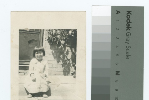 Nisei girl sitting outside (ddr-densho-255-75)