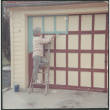 Agnes Sakura painting garage trim (ddr-densho-523-326)