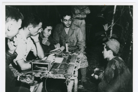 Philip Ishio and Arthur Uchiro interrogating a Japanese prisoner of war (ddr-densho-1007-397)