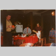 Tomoye and Henri Takahashi standing by table with gifts (ddr-densho-426-1295)