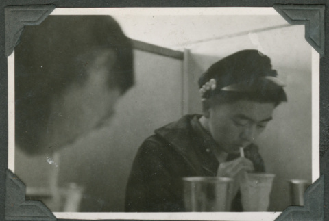 Two men drinking from straws (ddr-densho-540-34)