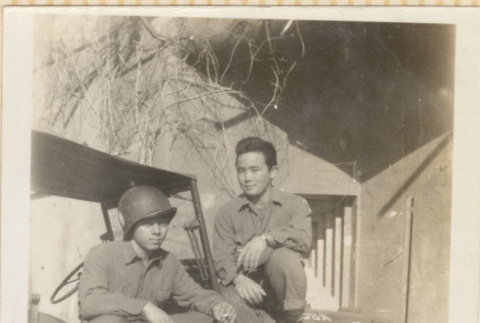 Two men sitting on jeep (ddr-densho-466-357)
