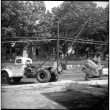 Men moving a large tree using a Neptune storage truck (ddr-densho-377-1548)