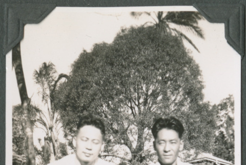 Two men sitting in grass (ddr-ajah-2-582)