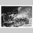 [Men in military uniform splitting firewood] (ddr-csujad-1-43)