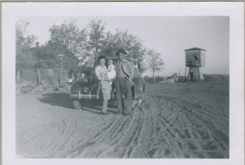 A family standing in front of a car (ddr-densho-300-33)