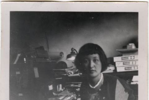 Woman at desk with paperwork (ddr-densho-426-889)