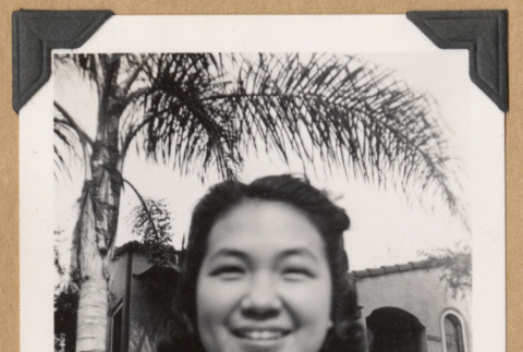 Smiling girl outside a home (ddr-densho-542-222)