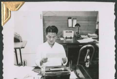 Man sitting at desk working (ddr-densho-434-247)