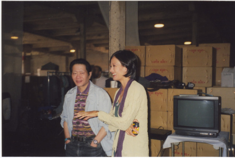 Man and woman standing by boxes (ddr-densho-426-379)