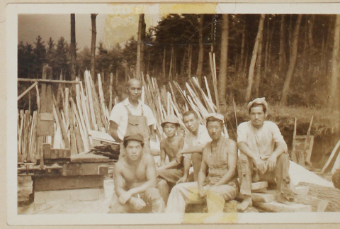 Six people surrounded by lumber (ddr-densho-433-718)