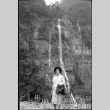 Tomoye (Nozawa) Takahashi standing by waterfall (ddr-densho-426-2414)