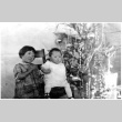 Toddler and baby in front of Christmas tree (ddr-densho-494-23)