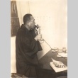 Buddhist priest speaking into a telephone (ddr-njpa-4-313)