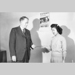 Camp administrator handing a woman a document (ddr-fom-1-405)