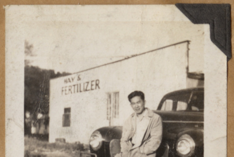 Man leaning on a fender (ddr-densho-542-158)