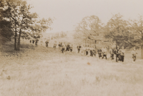 Soldiers walking through field (ddr-janm-17-17)