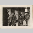 Group of men walking down street (ddr-densho-466-400)