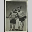 Two Japanese American soldiers in swimming trunks on a beach (ddr-densho-201-397)