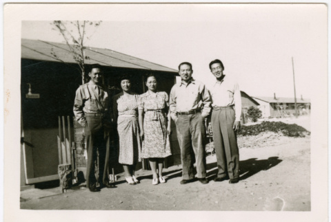 Tsukada Siblings standing outside barracks at Amache (ddr-densho-329-1346)