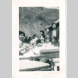 Group of women and children sitting at outdoor table (ddr-densho-430-187)