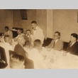 A man standing speaking to others seated at a table (ddr-njpa-4-127)