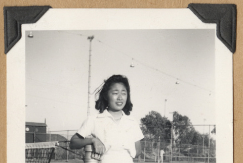 Young woman on a tennis court (ddr-densho-542-233)
