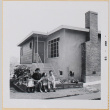 Yoshiko, William, Susan and Leslie Shiomi sitting on steps of house (ddr-densho-522-494)