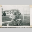 Two servicemen sitting on a bench (ddr-densho-321-1076)