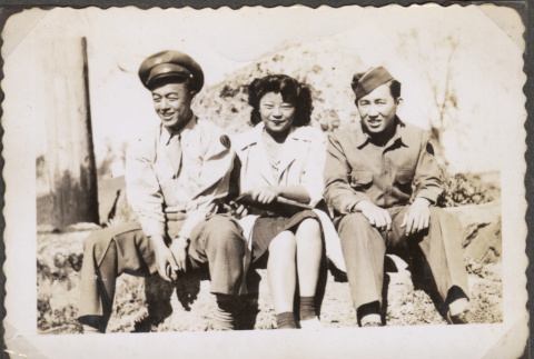 Two men in uniform sitting with woman (ddr-densho-466-68)