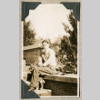 Man sitting on steps with pipe (ddr-densho-383-59)