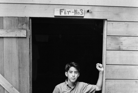 Gordon Honda standing in the doorway of cabin #3 (ddr-densho-336-233)