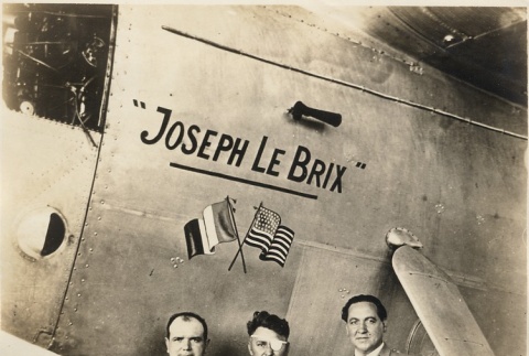 Three men standing in front of the 