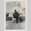 Soldier sitting in front of statue (ddr-densho-368-202)