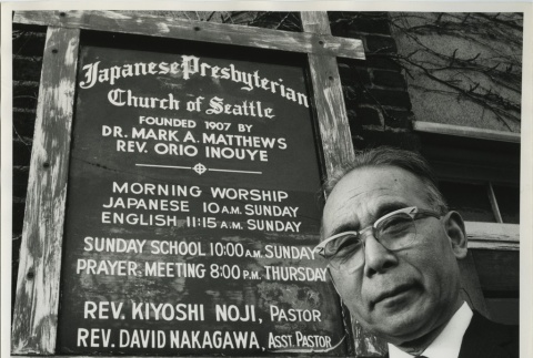 Issei man in front of church sign (ddr-densho-140-25)